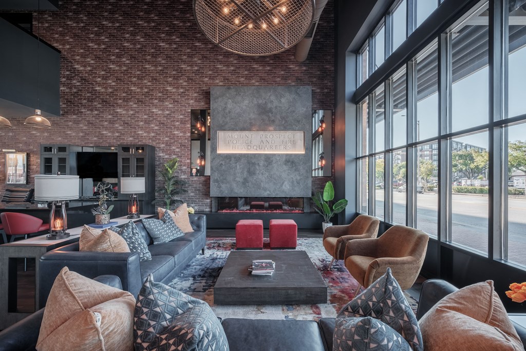 a living room with couches and chairs and a fireplace