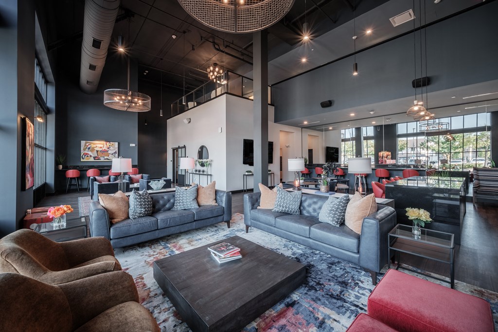 a living room with couches and chairs and a table