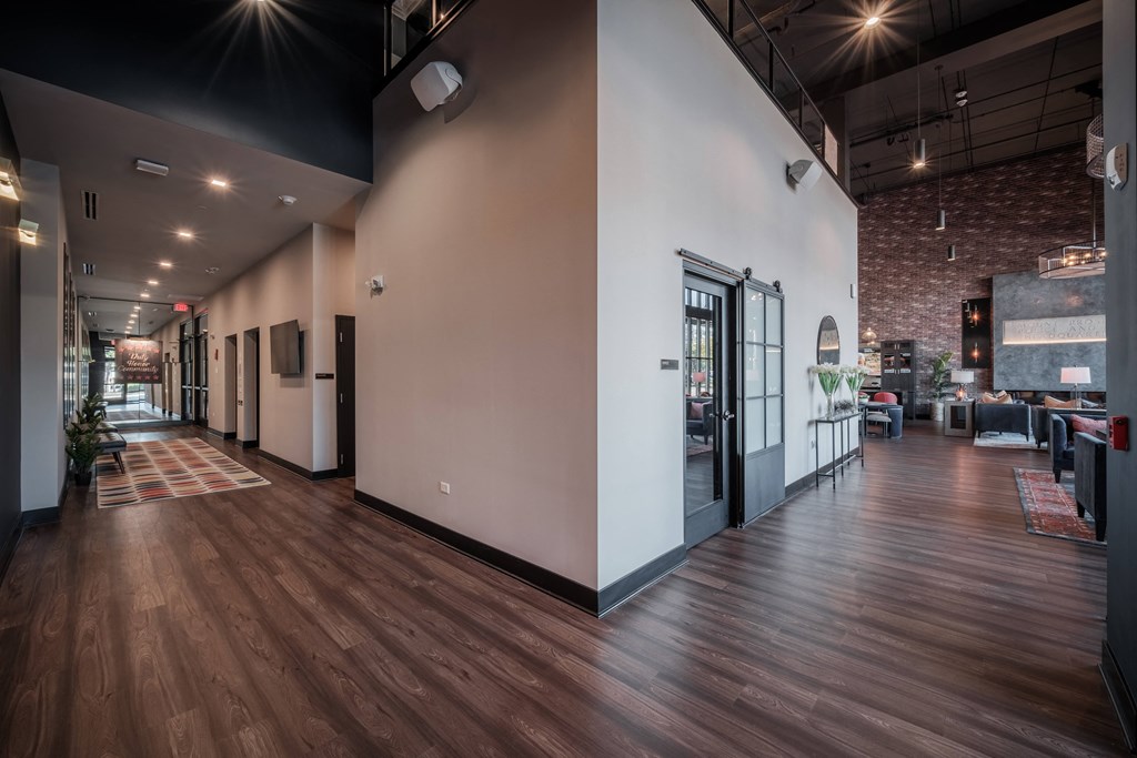 a large lobby with white walls and wood floors