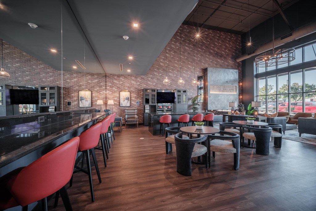 a dining room with tables and chairs and a bar