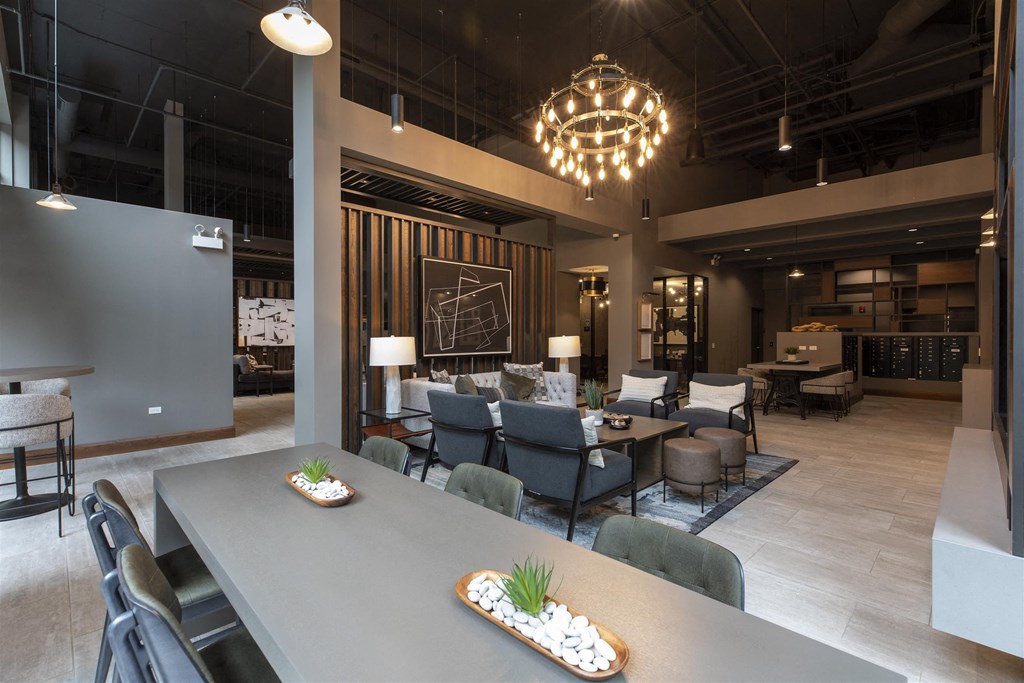 A modern dining area with a long table and chairs.