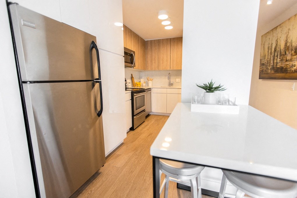 a kitchen with stainless steel appliances and a white counter top at The Kent, Illinois