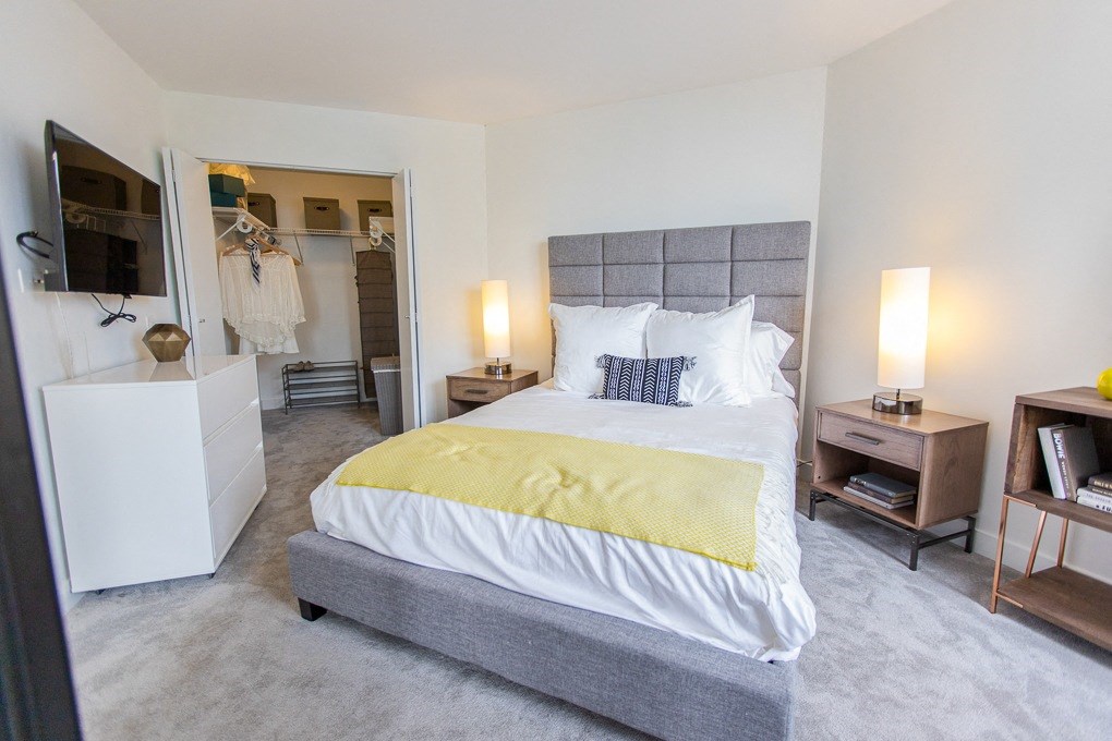 a bedroom with a bed and a closet and a mirror at The Kent, Chicago, Illinois