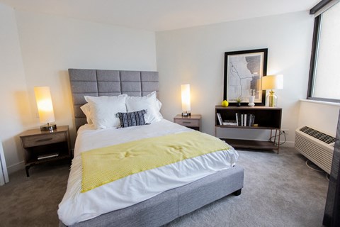 a bedroom with a bed and a large window at The Kent, Chicago, IL, 60614
