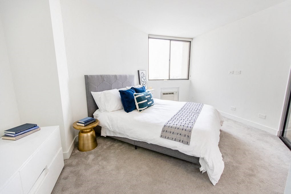 a bedroom with a bed and a window at The Kent, Chicago, Illinois
