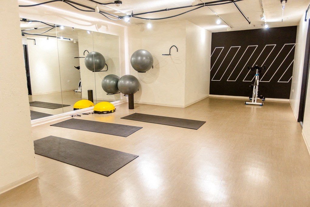 a fitness room with yoga mats and spheres on the floor at The Kent, Chicago