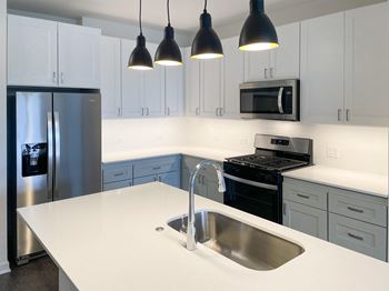 a kitchen with white counter top and stainless steel appliances at Enclave Crystal Lake Townhomes and Apartments, Crystal Lake, 60014