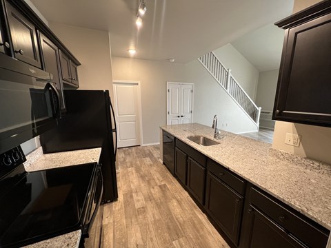 Kitchen with black appliances at Fountain Ridge, Pleasant Prairie, 53158