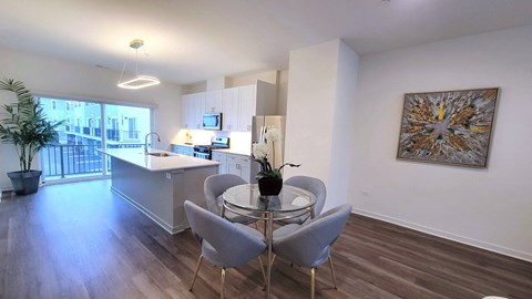 a kitchen and dining area with a glass table and chairs