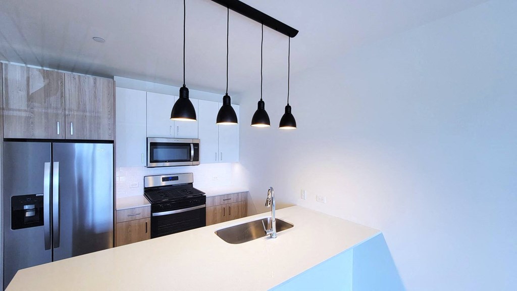 a kitchen with a sink and a refrigerator