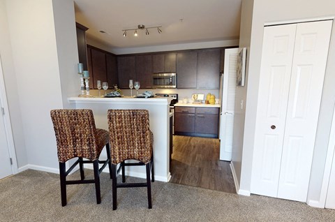 Two chairs are in front of a kitchen island.