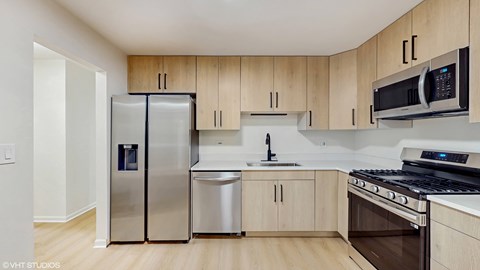 A kitchen with wooden cabinets and stainless steel appliances.
