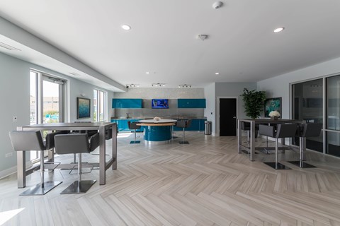 A modern dining room with a long table and chairs.