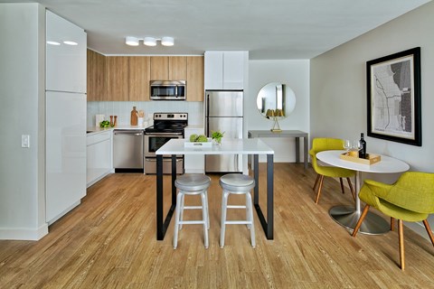 A modern kitchen with a dining table and chairs.
