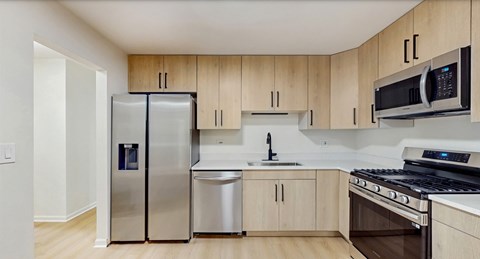 A kitchen with wooden cabinets and stainless steel appliances.