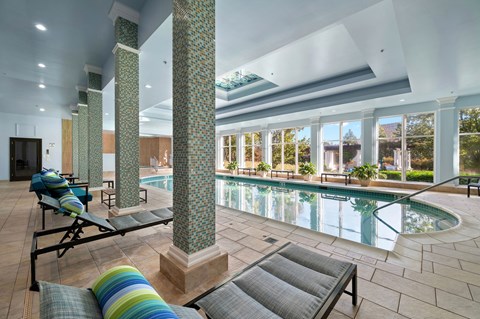 Indoor swimming pool with relaxing seating.