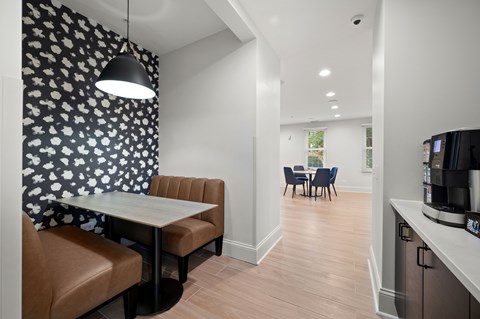 A modern kitchen with a dining table and chairs.