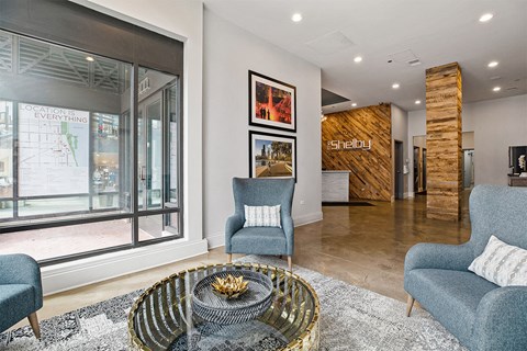 A living room with a sofa, a chair and a coffee table.