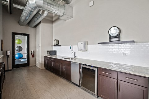 A kitchen with a white counter top and brown cabinets.