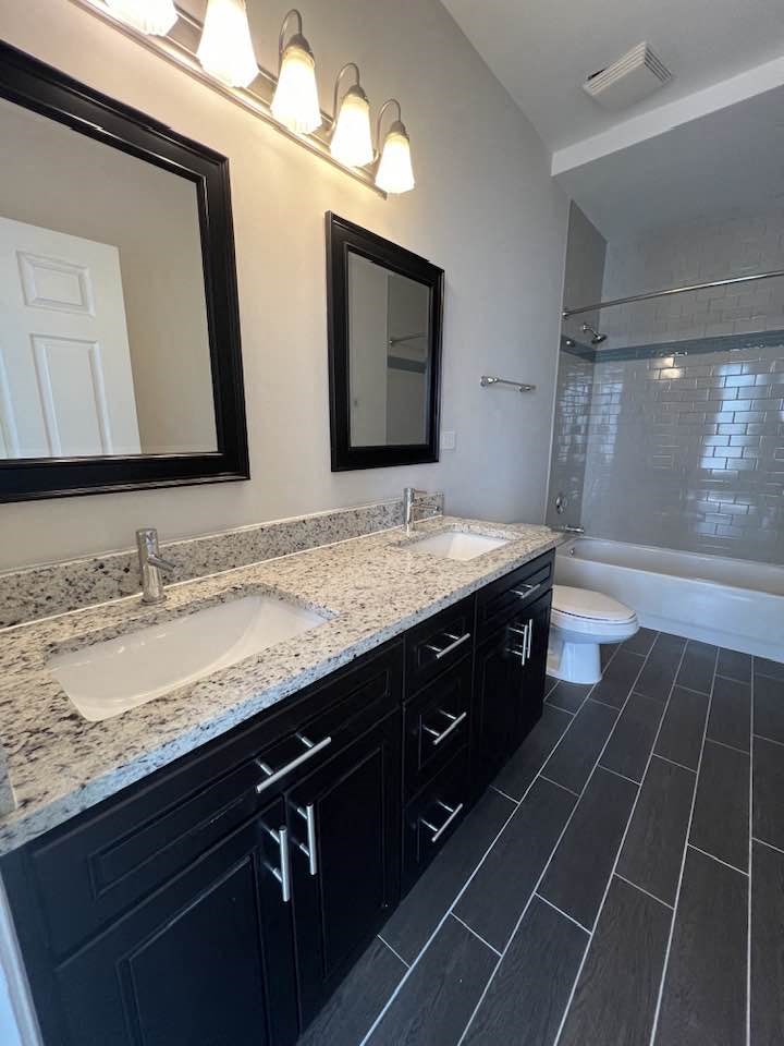 a bathroom with a sink and a toilet and a mirror