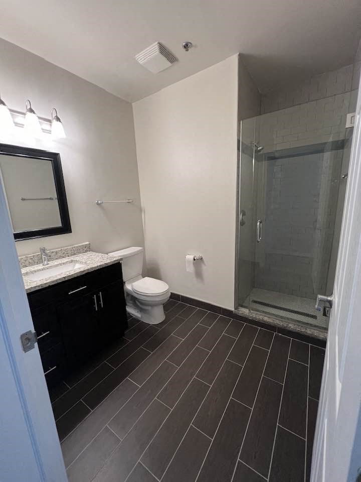 a bathroom with a toilet and a shower