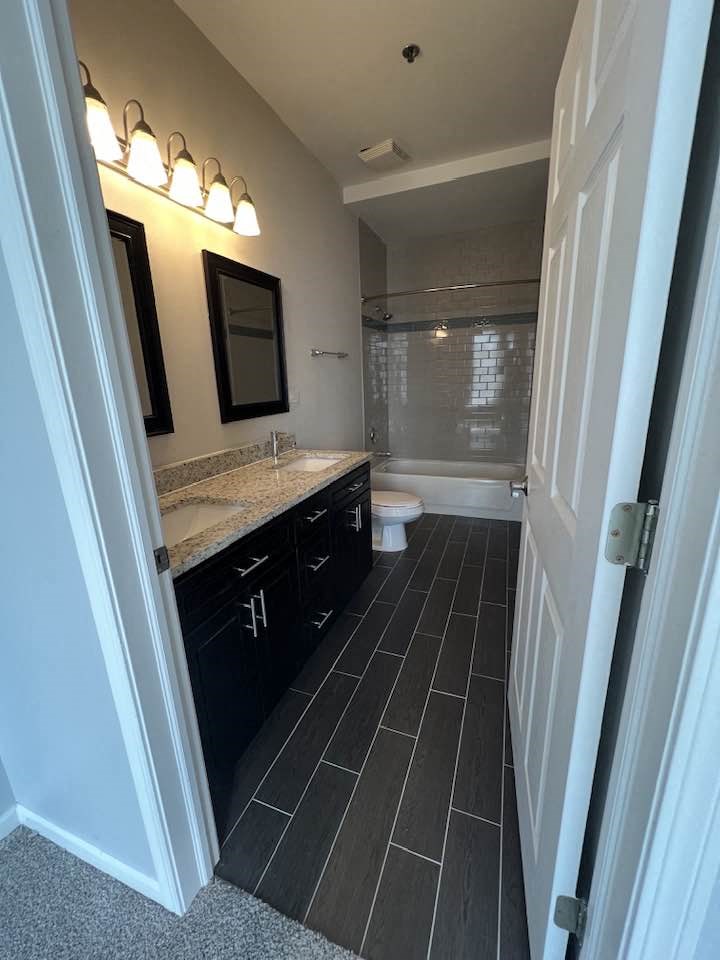 a bathroom with a sink and a toilet and a shower
