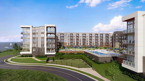 A modern apartment complex with a pool and a view of the ocean.