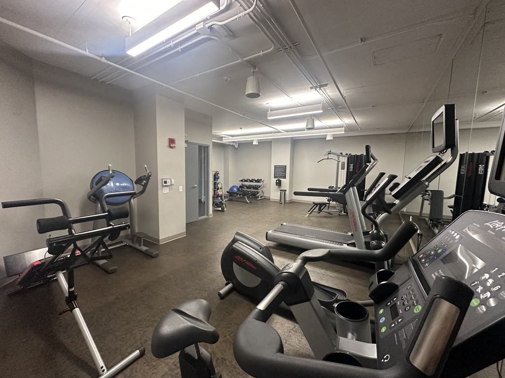 a gym with weights and other exercise equipment in a building