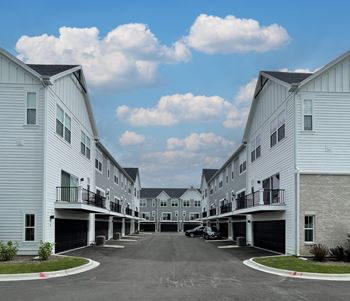 a row of white houses with balconies at Enclave Crystal Lake Townhomes and Apartments, Illinois