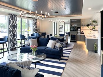 a living room with blue couches and a glass coffee table at Enclave Crystal Lake Townhomes and Apartments, Crystal Lake, IL, 60014
