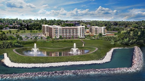 A large building complex with a fountain in front of it.