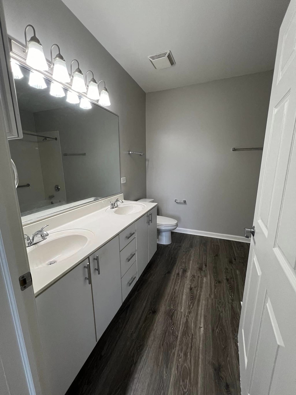 a bathroom with two sinks and a toilet