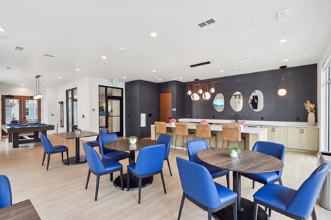 A modern dining room with blue chairs and wooden tables at 2929 on Mayfair, Wauwatosa, 53222