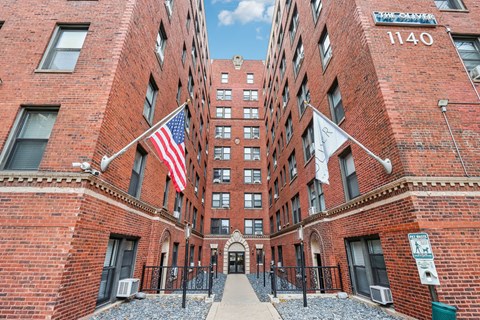 A red brick building with the number 1140 on the top right corner.