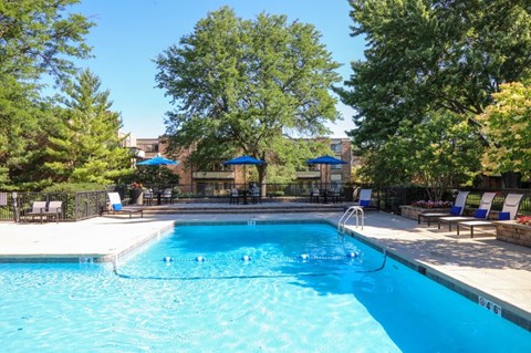 a swimming pool with trees and chairs around it at Fieldpointe of Schaumburg, Schaumburg, 60173