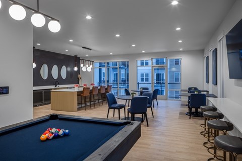 a communal area with a pool table and tables and chairs and a bar at 2929 on Mayfair, Wauwatosa, Wisconsin