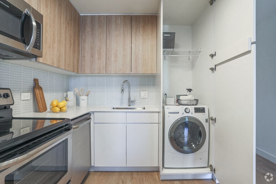 A modern kitchen with a washing machine at The Kent, Chicago, Illinois