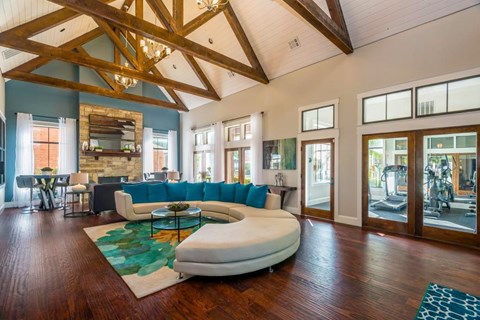 The leasing offie at Fusion Crossroads with a white couch and a wooden floor at 1601 Eastchase Pkwy in Fort Worth, TX.