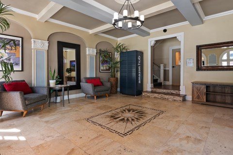 A living room with a rug in the middle and a chandelier hanging from the ceiling.