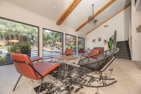 Fusion 35 clubhouse with a red chair and a black and white rug.