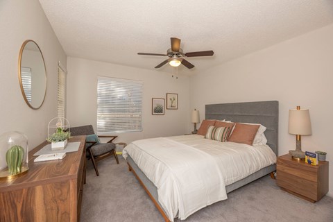 Fusion 3 bedroom with a bed, nightstand, and a ceiling fan.