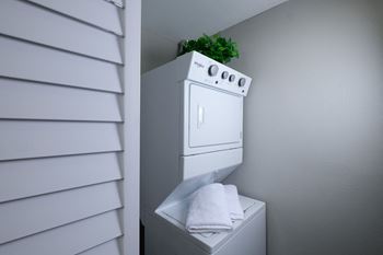 Stacked laundry in Mandarin bay 1-bedroom apartment with washer and dryer hookups in-unit.