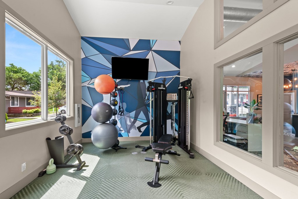 Retreat at Indian Lake Apartments Hendersonville TN gym with a television, weights, and exercise equipment.