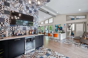 Coffee bar in the leasing office at The Retreat at Indian Lake Apartments with a black and white tiled wall.