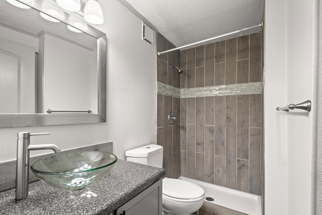 The Retreat at Indian Lake Apartments for rent in Hendersonville TN modern bathroom with a glass bowl sink and a walk-in shower.