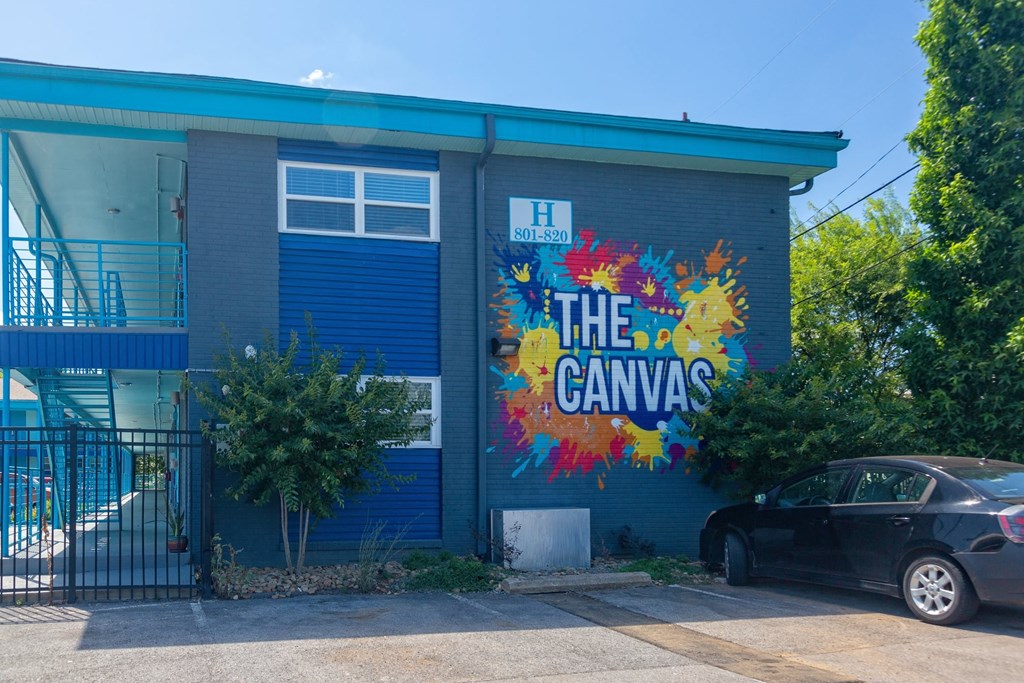 The Canvas apartments in Nashville, Tennessee exterior with large mural of multicolored paint splatters and "The Canvas"
