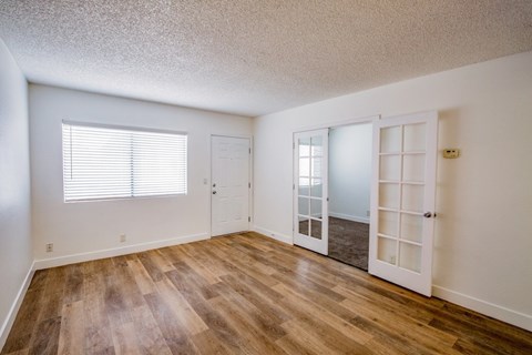 A room with wooden floors and white walls.