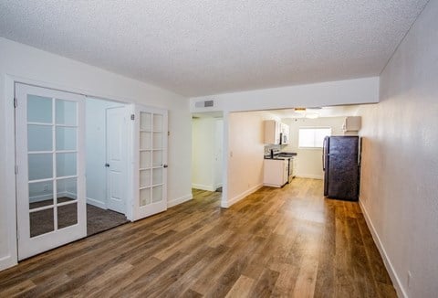 A room with wooden floors and white walls.