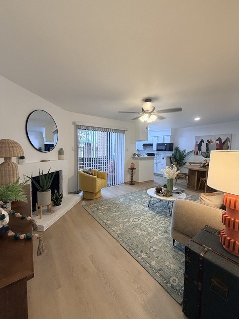 Fusion Crossroads living room with a fireplace, a yellow chair, and a rug.