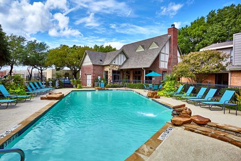 A large swimming pool with Fusion Crossroads Apartments in the background.